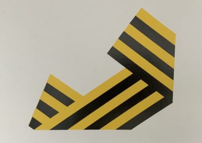 Geometric shape with yellow and black stripes.